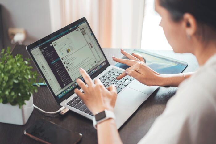 A person working on a laptop, illustrating the versatility and remote work opportunities provided by an internationally recognized management degree